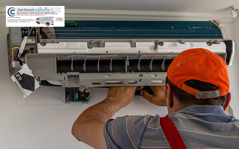 A technician inspecting a faulty aircon unit from Cool Channels Engineering