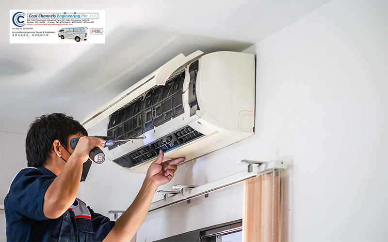 A technician cleaning an aircon