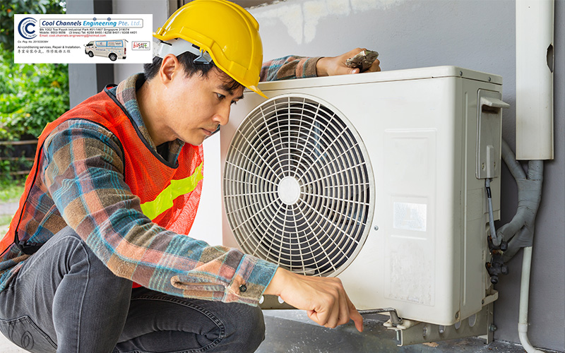 Professional assessment of an outdoor unit during aircon installation.