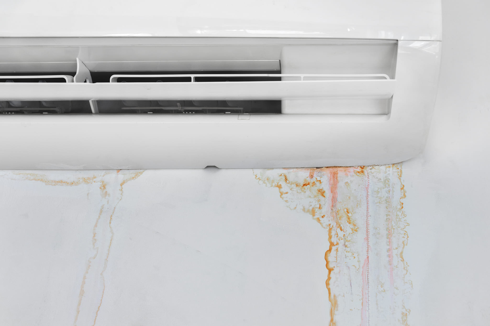 wall with mold stain due to air conditioner leakage