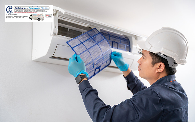 Cool Channels technician cleaning aircon filters during routine maintenance.
